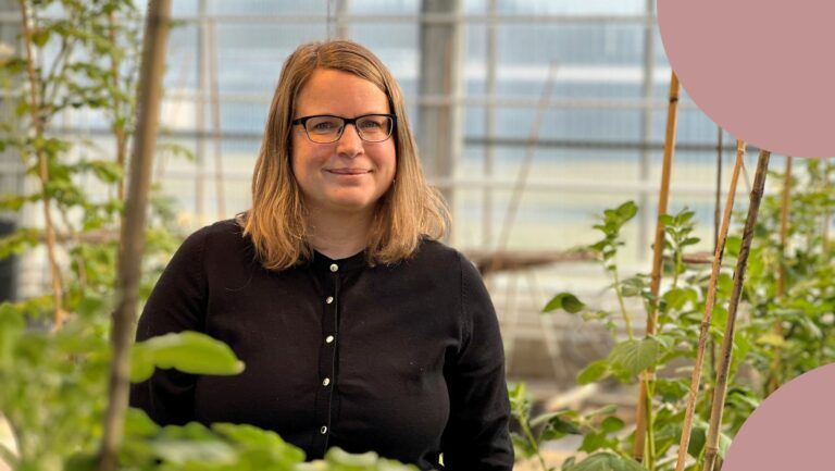 annie drottberger stands in a greenhouse.