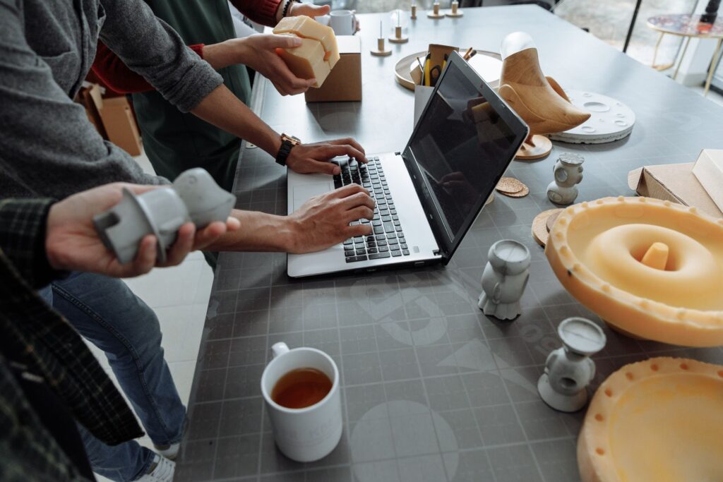 People sitting at a table working on ideas and prototypes.