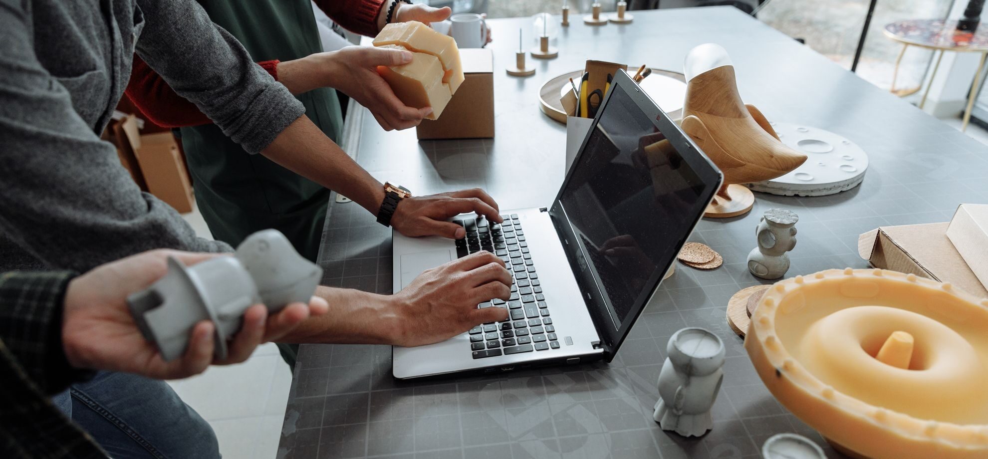 People sitting at a table working on ideas and prototypes.